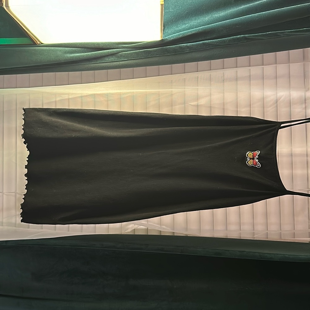 Medium , short, black dress with butterfly on front.